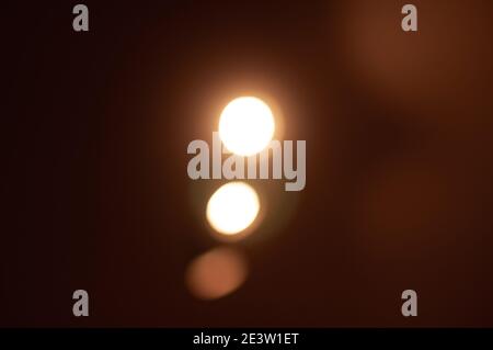light from a source of yellow lanterns on a dark background Stock Photo