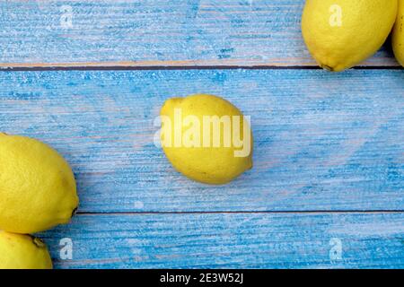 Freshly lemons on rustic blue wooden board background Stock Photo