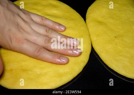 Hands of a young woman, kneading dough to make bread. Stock Photo