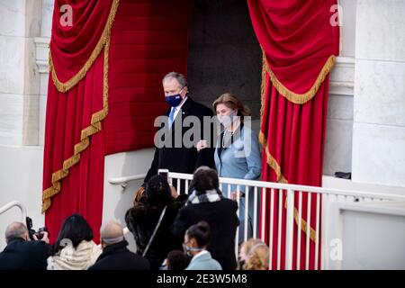 (210120) -- WASHINGTON, Jan. 20, 2021 (Xinhua) -- Former U.S. President George W. Bush (L, Rear) and his wife Laura Bush arrive to attend the inauguration ceremony of the 46th President of the United States in Washington, DC, the United States, on Jan. 20, 2021. At an unusual inauguration closed to public due to the still raging coronavirus pandemic, U.S. President-elect Joe Biden was sworn in as the 46th President of the United States on Wednesday at the West Front of the Capitol, which was breached two weeks ago by violent protesters trying to overturn his election victory. (Xinhua/Liu Jie Stock Photo