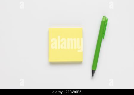 Self-stick yellow note pad or sticky note and pen Stock Photo