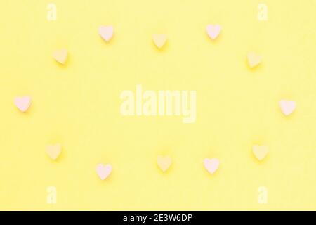 Romantic pastel yellow backround with hearts decoration Stock Photo