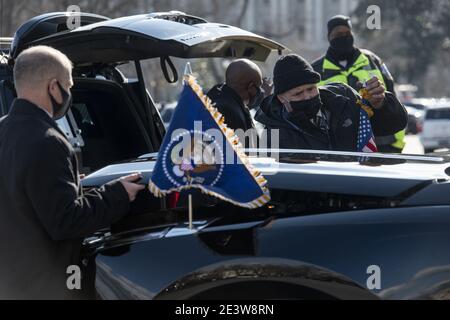 Washington, United States. 20th Jan, 2021. Secret Service agents attach flags and decals on the new car of United States President Joe Biden parked at the US Capitol following the inauguration of United States President Joe Biden and Vice President Kamala Harris in Washington, DC on Wednesday, January 20, 2021. Pool Photo by Rod Lamkey/UPI Credit: UPI/Alamy Live News Stock Photo