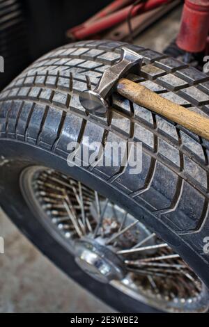 old hammer on wheel and tire garage workshop. Stock Photo