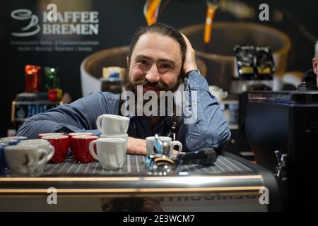 Portrait of smiling Barista with coffee equipment, espresso coffee machine, coffee grinder, cups for making drinks Stock Photo