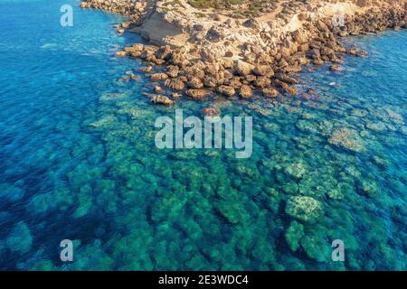 Aerial view of yellow stone island coast with azure and blue tropical sea water, summer travel concept, beautiful nature landscape.