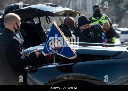 Secret Service agents attach flags and decals on the new car of United States President Joe Biden, parked at the US Capitol in Washington, DC on Wednesday, January 20, 2021. Credit: Rod Lamkey/Pool via CNP | usage worldwide Stock Photo
