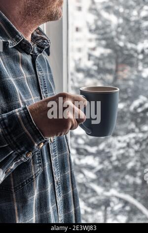 Hot Coffee cup on a frosty winter day window background