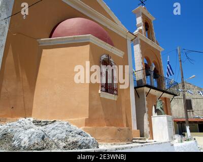 Greek flag flying outside church in Xanthates, Corfu, Greece Stock Photo