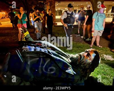 MAN DOWN: June 19, 2020, Washington, DC, USA: Police documenting BLM vandals attack of the statue of Brig. Gen. Albert Pike in Judiciary Square. Black Lives Matter demonstrators arrived at 10 pm lynched and then toppled it off its base to the ground. Then set it on fire and further vandalized with spray paint. The 1901 statue honoring an American author, poet, journalist, orator, jurist, a major advocate for American Indian rights and prominent member of the Freemasons, was also a senior officer of the Confederate States Army. Pike's statue was the city's lone monument to a person who was a Co Stock Photo