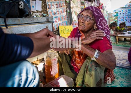 Rajasthan. India. 07-02-2018. Old woman in India receiving treatment from a doctor who work for a Non government organization. Stock Photo