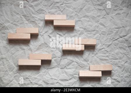 background of crumpled craft paper with wooden rectangles arranged in a certain order in a minimalist style Stock Photo