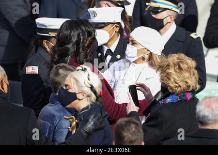 Washington, USA. 20th Jan, 2021.First Lady Michelle Obama and Jennifer Lopez hug during the Inauguration Day ceremony of President-Elect Joe Biden and Vice President-Elect Kamala Harris held at the U.S. Capitol Building in Washington, D.C. on Jan. 20, 2021. President-elect Joe Biden becomes the 46th President of the United States at noon on Inauguration Day. (Photo by Oliver Contreras/Sipa USA) Stock Photo