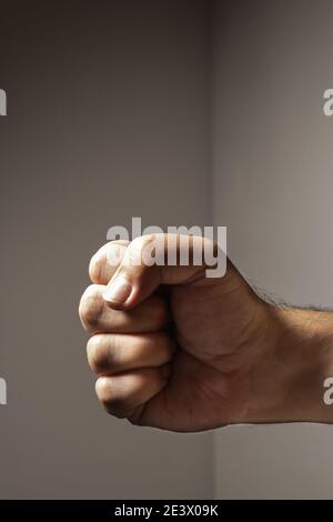 Clenched fist of a white male forward and sideways. Concepts of strength and anger. Stock Photo