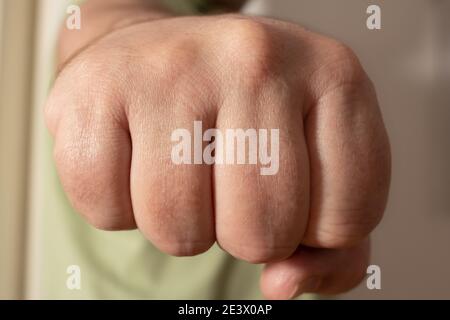 Right clenched fist of a white man forward. Concepts of strength, fight. Pandemic greeting between friends. Stock Photo