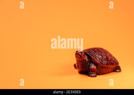 Small sculpture of a terra cotta colored African tortoise walking. Stock Photo