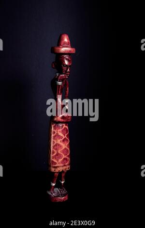 Traditional African sculpture of a man in colored wood. Stock Photo