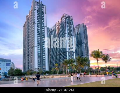 People enjoy entertainment at the large courtyard in the afternoon in a modern, international apartment complex in Ho Chi Minh City, Vietnam Stock Photo