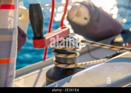 Winch with red and white rope on sailing boat in the sea Stock Photo - Alamy