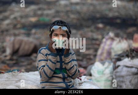 18 January 2021, India, Neu Delhi: Ten-year-old Shekh Zahid shows the money he earned after selling recyclable items while collecting garbage at the Bhalswa garbage dump. The fourth-grader from Malda in West Bengal, whose father works as a rickshaw driver, started working during the October 2020 lockdown as schools were closed. His family sent him to Delhi to stay with an uncle who was already working as a rag picker. Shek earns 150 rupees, about 1.70 euros, a day collecting recyclable material at the garbage dump. (to dpa 'Blight of the world: poverty forces millions of children to work') Pho Stock Photo