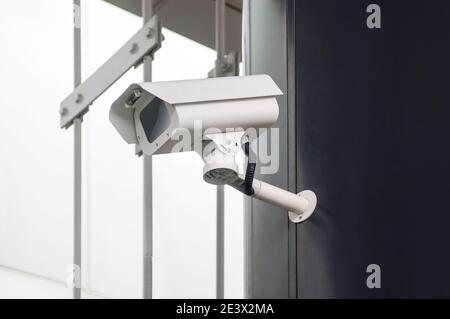 Security camera on black wall Stock Photo