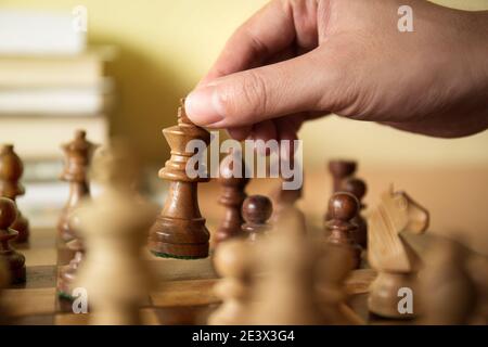 Male hand moving the white chess king during the game of chess Stock Photo