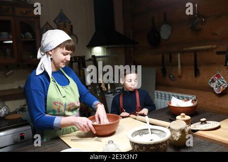Cook making dough in bowl in kitchen Stock Photo