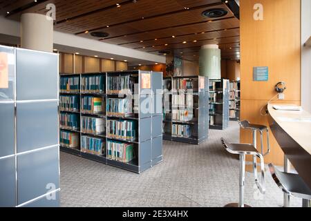Modern public library interior with bookshelves and study bar seating Stock Photo
