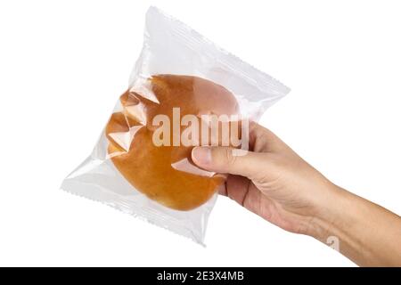 Hand holding transparent plastic bag with bread isolated on white with clipping path Stock Photo