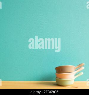 Colorful bowls on wooden table. mint green background Stock Photo