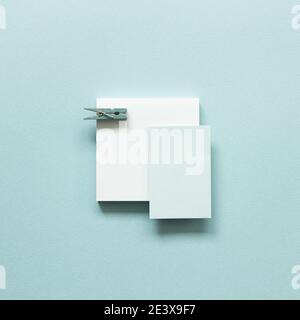 Blue memo pad with wooden clip on blue background. top view, copy space Stock Photo