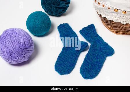 Blue knitted wool socks. Balls of multicolored yarn for knitting, handicrafts and hobbies Stock Photo