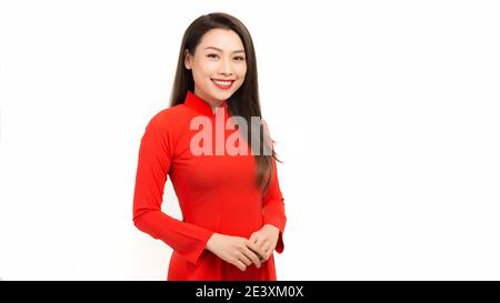 Young girls dressed in Vietnam culture traditional dress, standing over white background Stock Photo