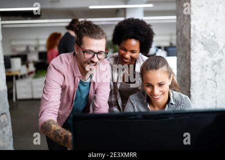 Programmers cooperating at IT company developing apps Stock Photo
