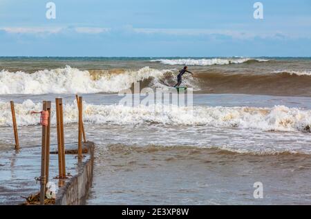 Imperia, Italy, 03/11/2020: professional surfer in training in the sea of Liguria, sports reportage Stock Photo