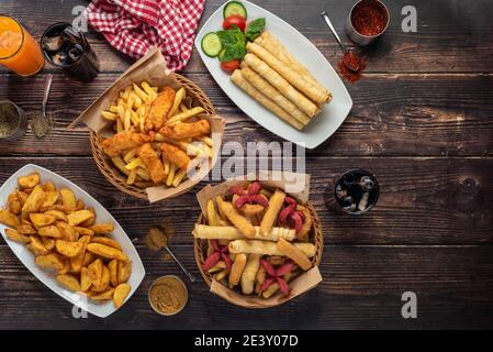 Beer plate Spicy chicken pieces, calamari rings, French fries onion rings, cheese balls, breaded. Stock Photo