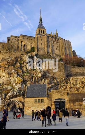 Le Mont Saint-Michel in winter. Crowd of tourists on the square at the bottom of the mount Stock Photo