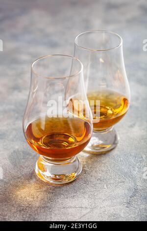 glass of whisky spirit brandy on gray concrete background Stock Photo