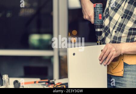 Man working during process of furniture manufacturing Stock Photo