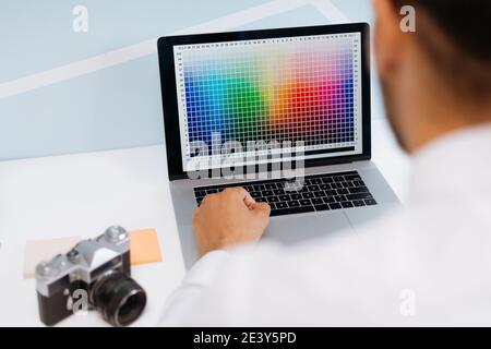 Retoucher photographer using laptop to edit photos. Stock Photo