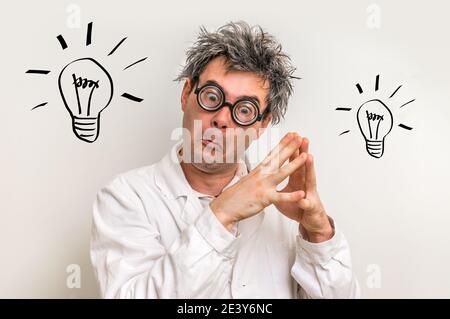 Crazy scientist got the great idea in laboratory with bulb symbol Stock Photo