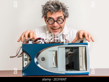 Crazy engineer or scientist repairing desktop computer Stock Photo