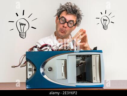 Crazy engineer or scientist repairing computer in laboratory with bulb symbol Stock Photo