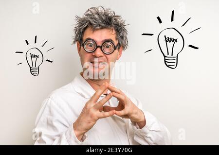 Crazy scientist got the great idea in laboratory with bulb symbol Stock Photo