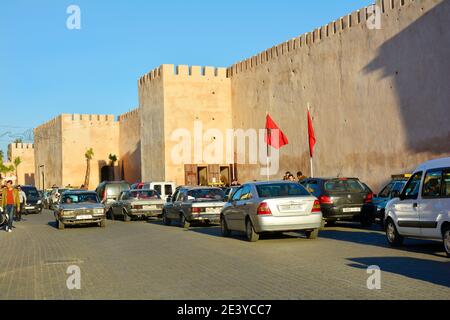Meknes, Morocco - November 19th 2014: Unidentified people and cars in front of the medieval city wall Stock Photo