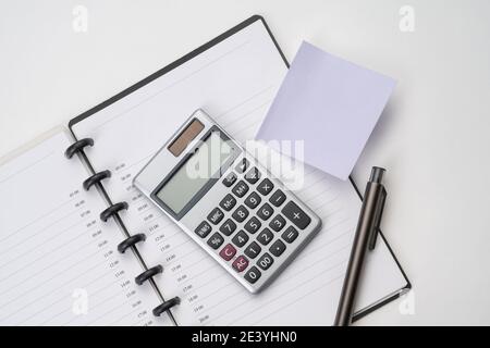 Topview of notebook with pen, calculator and sticky note Stock Photo ...