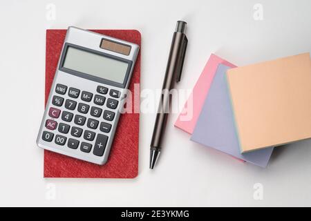 Topview of notebook with pen, calculator and sticky note Stock Photo