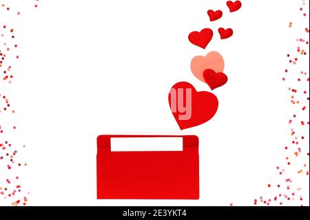 Valentines day. Love envelope with blank letter and many colored flying hearts on white isolated background Stock Photo