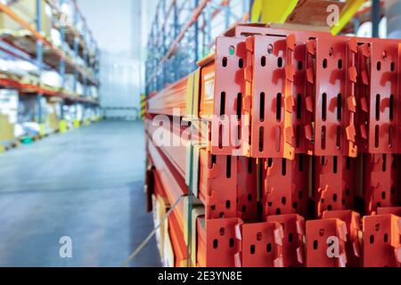 Warehouse premises of a factory or workshop with metal shelves. Stock Photo