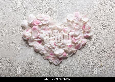 Heart made of white rose petals symbol of love, top view Stock Photo